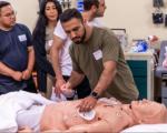 Students practice responding to cardiac arrest on mannequin